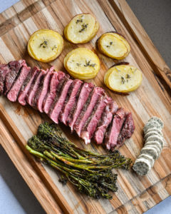Finished Bison Ribeye Steak with herb butter & pommes Anna - Urban Butcher